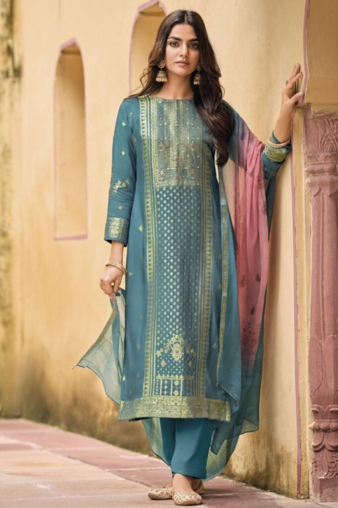 a indian girl well suited posing near a wall