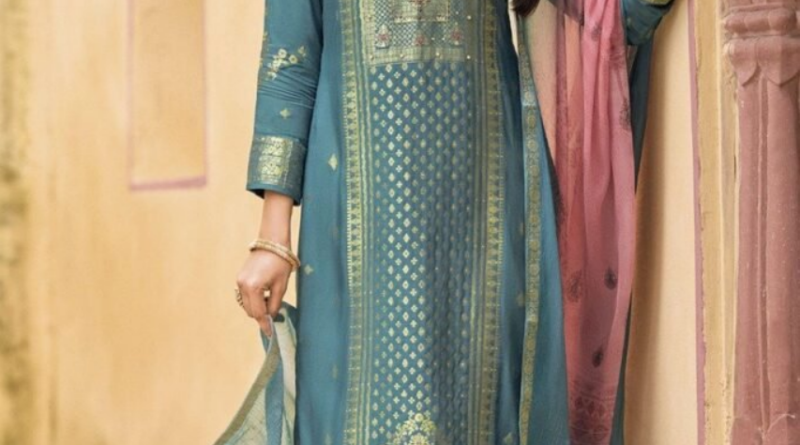 a indian girl well suited posing near a wall